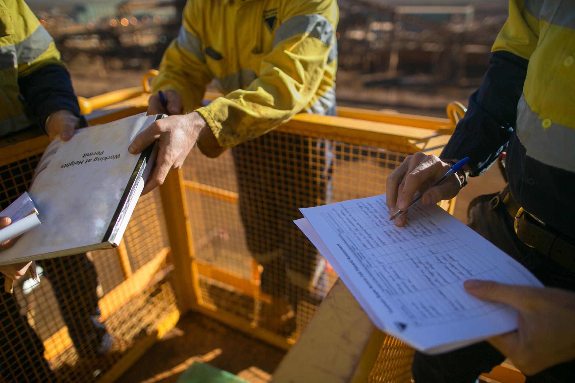 Trained miner supervisor checking reviewing document issued sign approvals of working at height