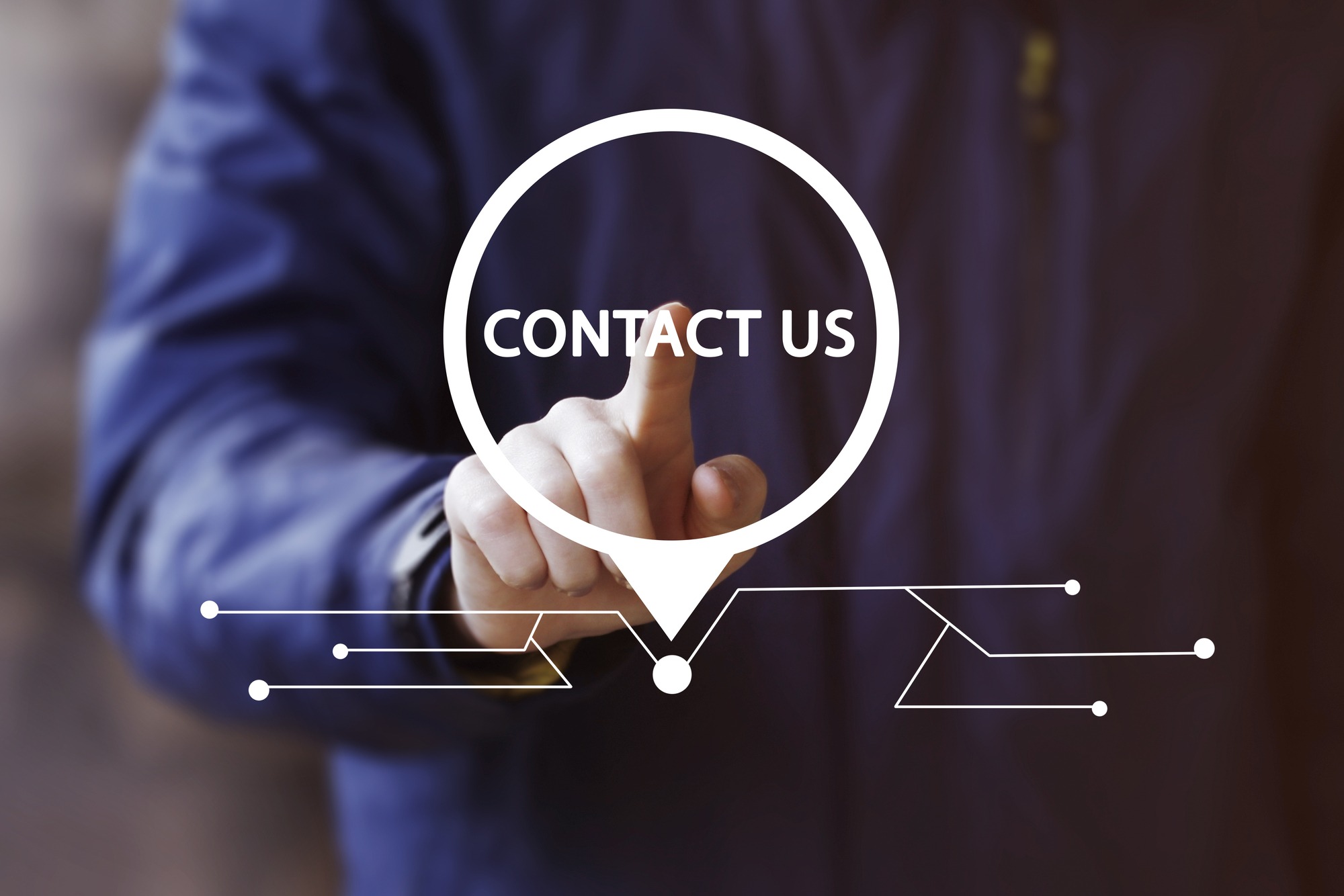 Businessman pressing button screen and selecting contact us network pointer.