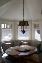 A cozy dining room featuring a wooden table surrounded by four matching chairs.